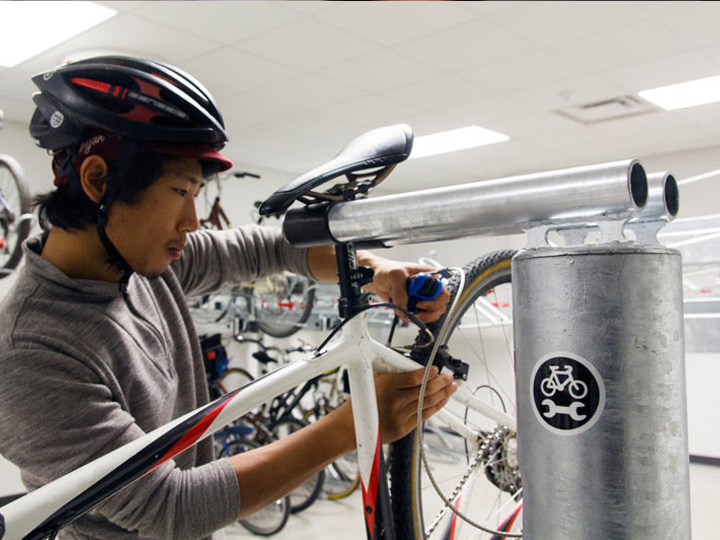 a person pumping a bike from a community pump