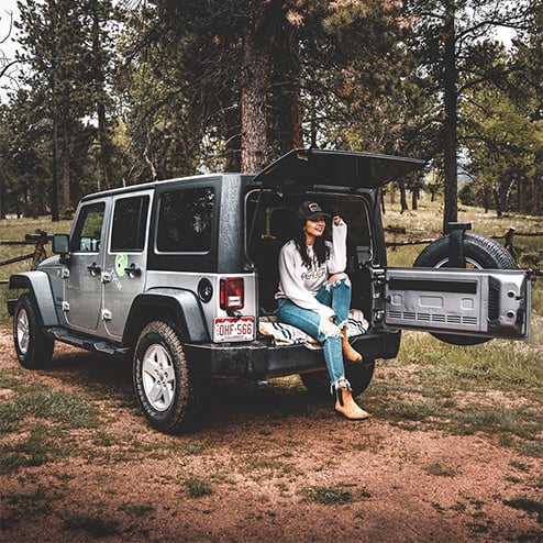 woman sitting in zipcar in forest