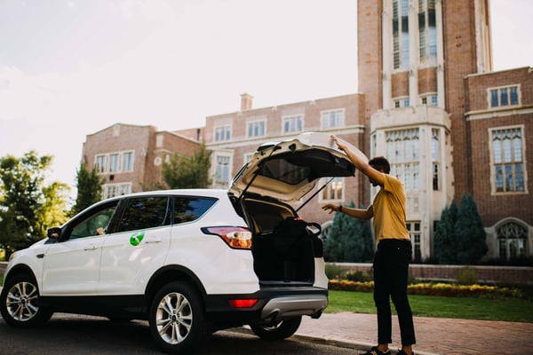 Student closing SUV trunk