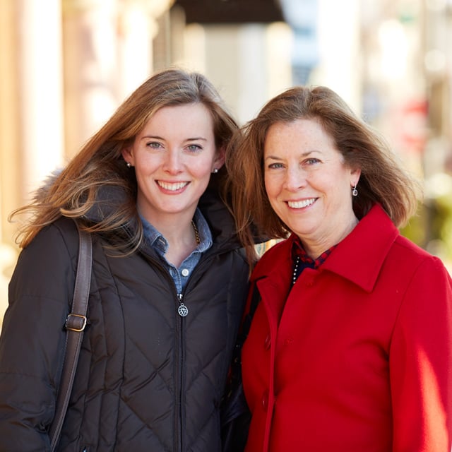 two middle-aged women smiling at the camera