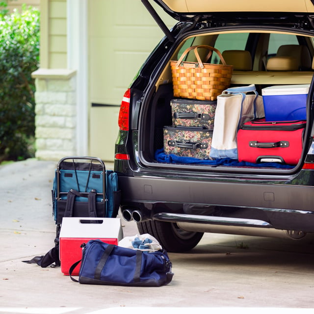 the back of a minivan full of luggage