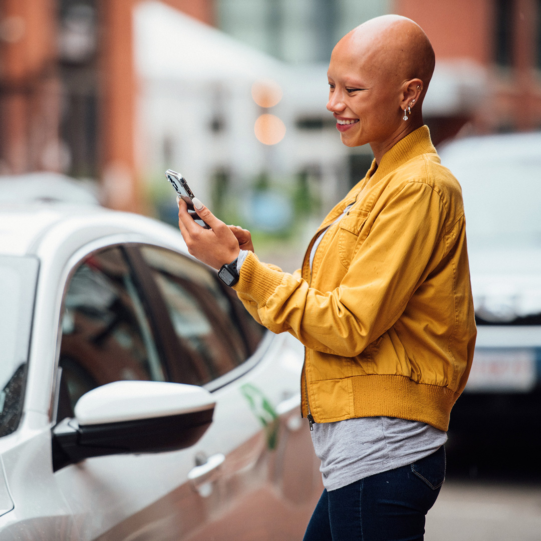 women using the zipcar app on her smartphone