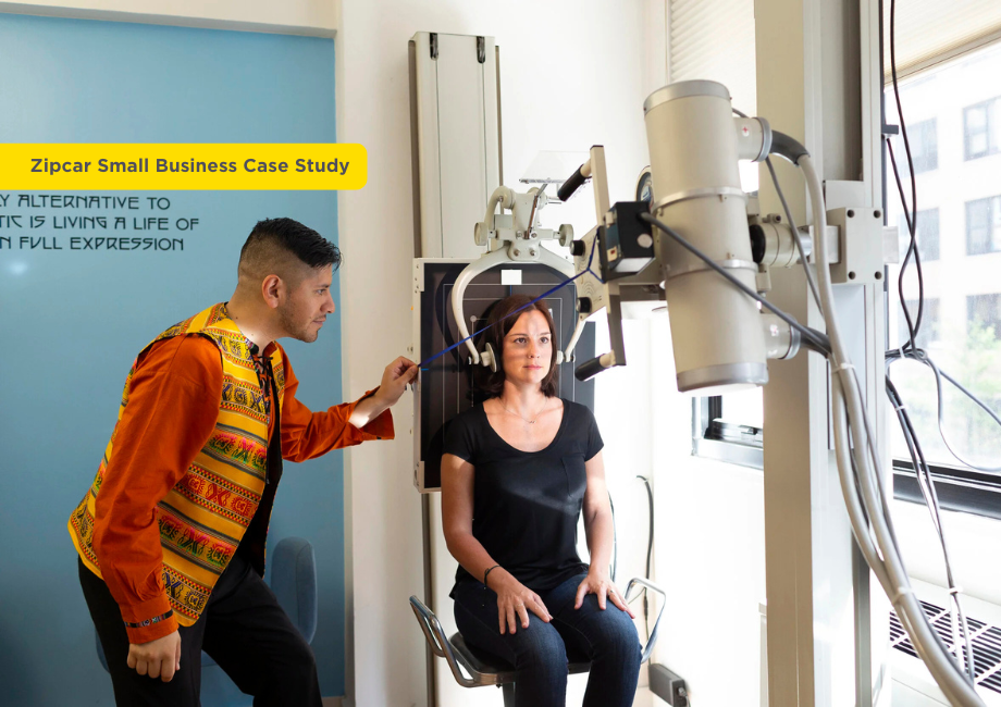 Chiropractor examining a woman sitting on medical equipment