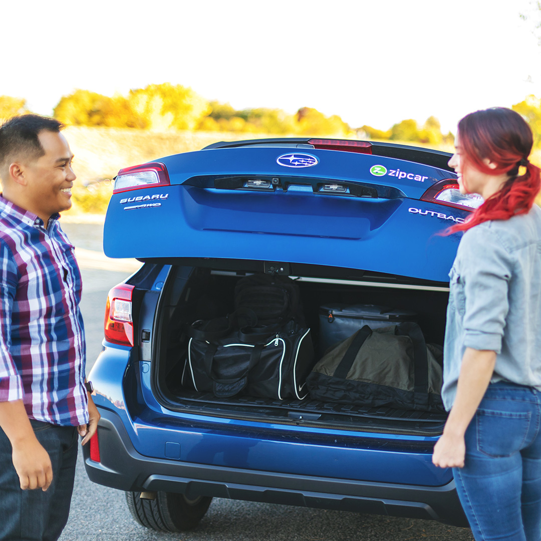 Friends sharing a Zipcar to reduce carbon emissions