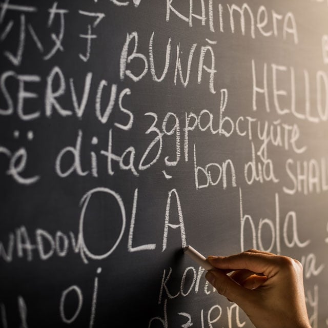 Chalkboard with different foreign languages written on it