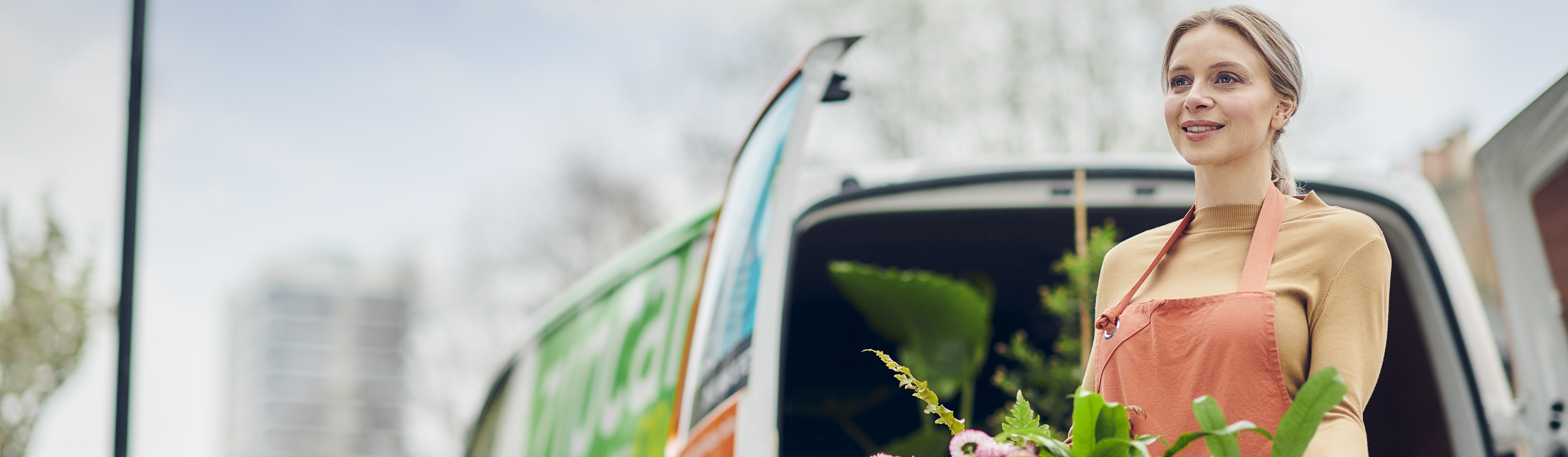 zipcar van woman holding plants