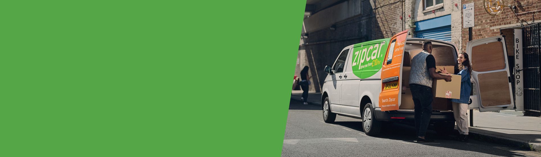Zipcar vans parked on a street 