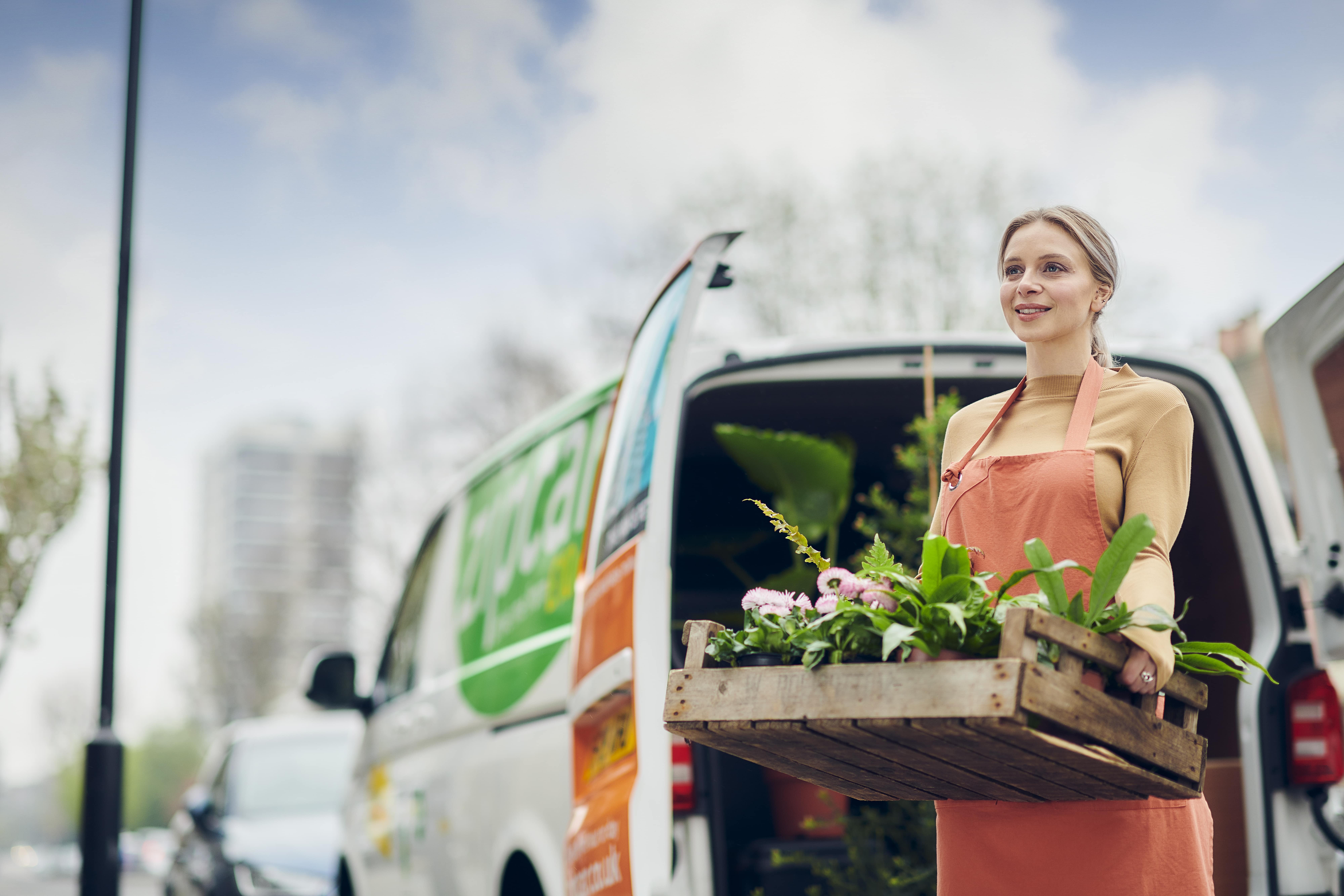 lady carrying out goods from van