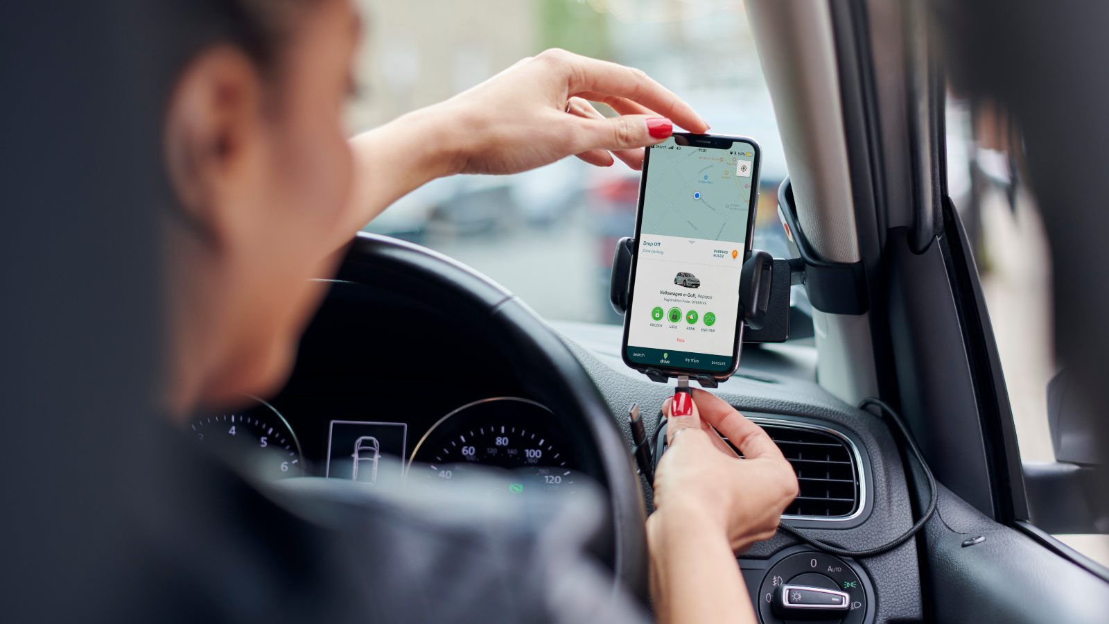 plugging in phone at the wheel of a zipcar