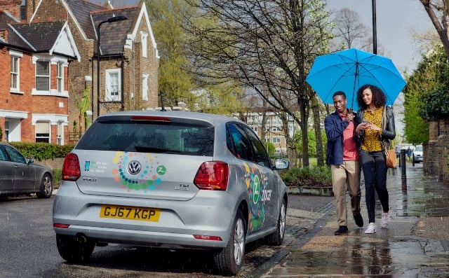 people walking up to a zipcar