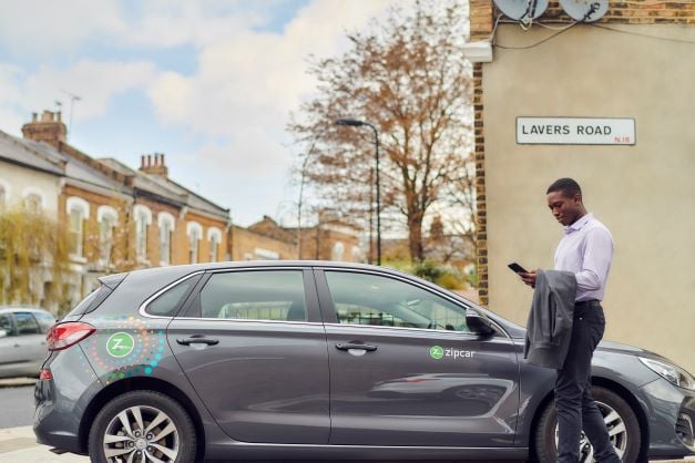 man on the phone next to car