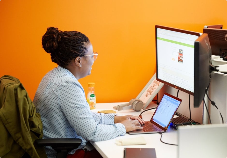 Woman sitting at desk in front of computer