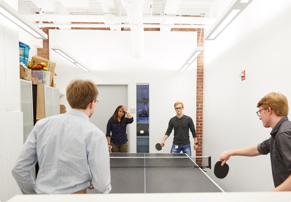 Four people playing ping pong